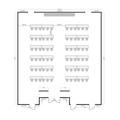 A conference or classroom layout with rows of tables and chairs facing a front stage/dais and a central entry.